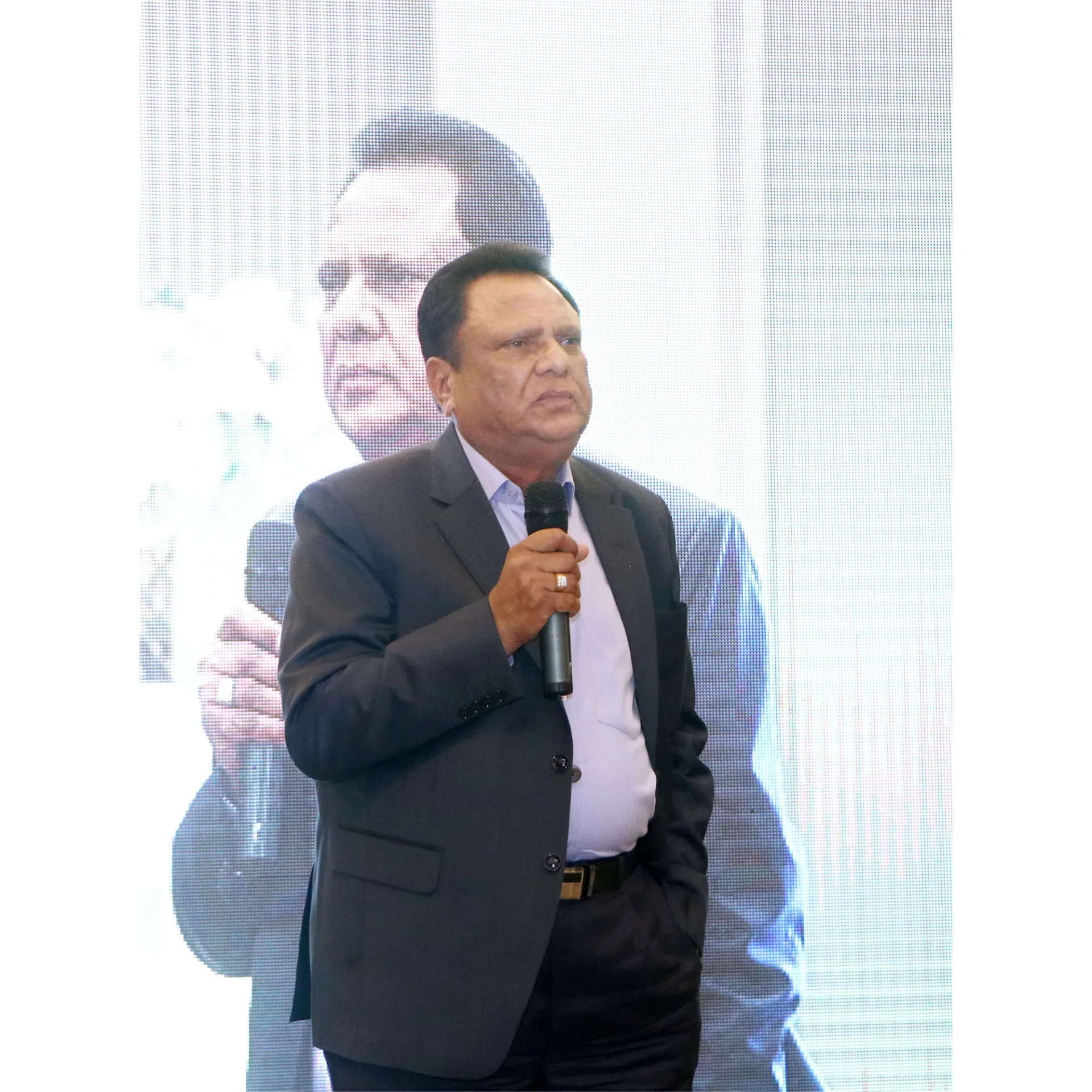 Suresh Pal addressing a gathering with a microphone